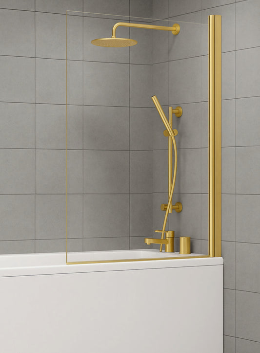 Gold shower set with a rain shower head and handheld shower against a gray tiled wall. Gold brushed brass square bath screen with toughened safety glass